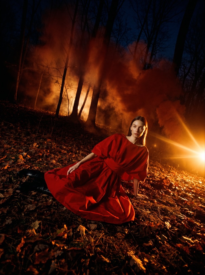 AI fashion model in a red dress with dramatic fire light