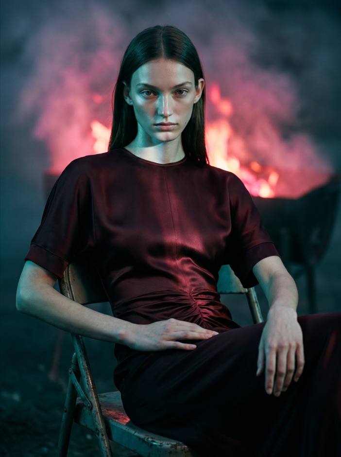 AI fashion model in a red dress by water with red smoke