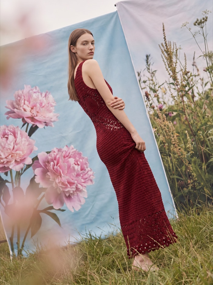 AI fashion model in a red dress among pink flowers
